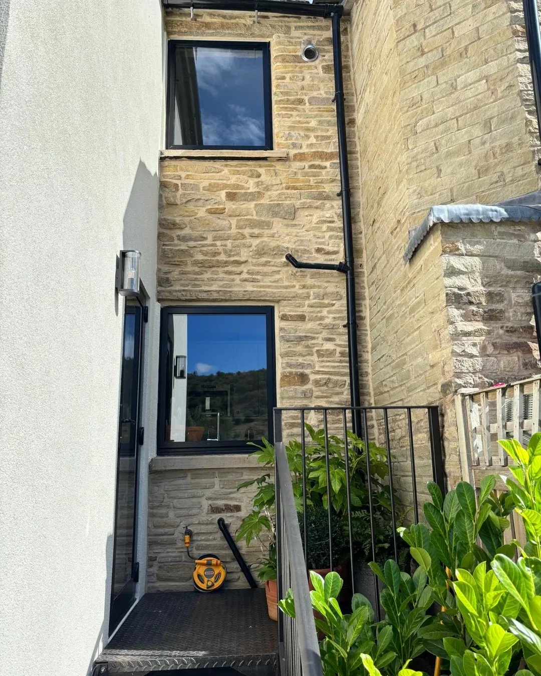 Exterior wall after original stonework was revealed and restored.