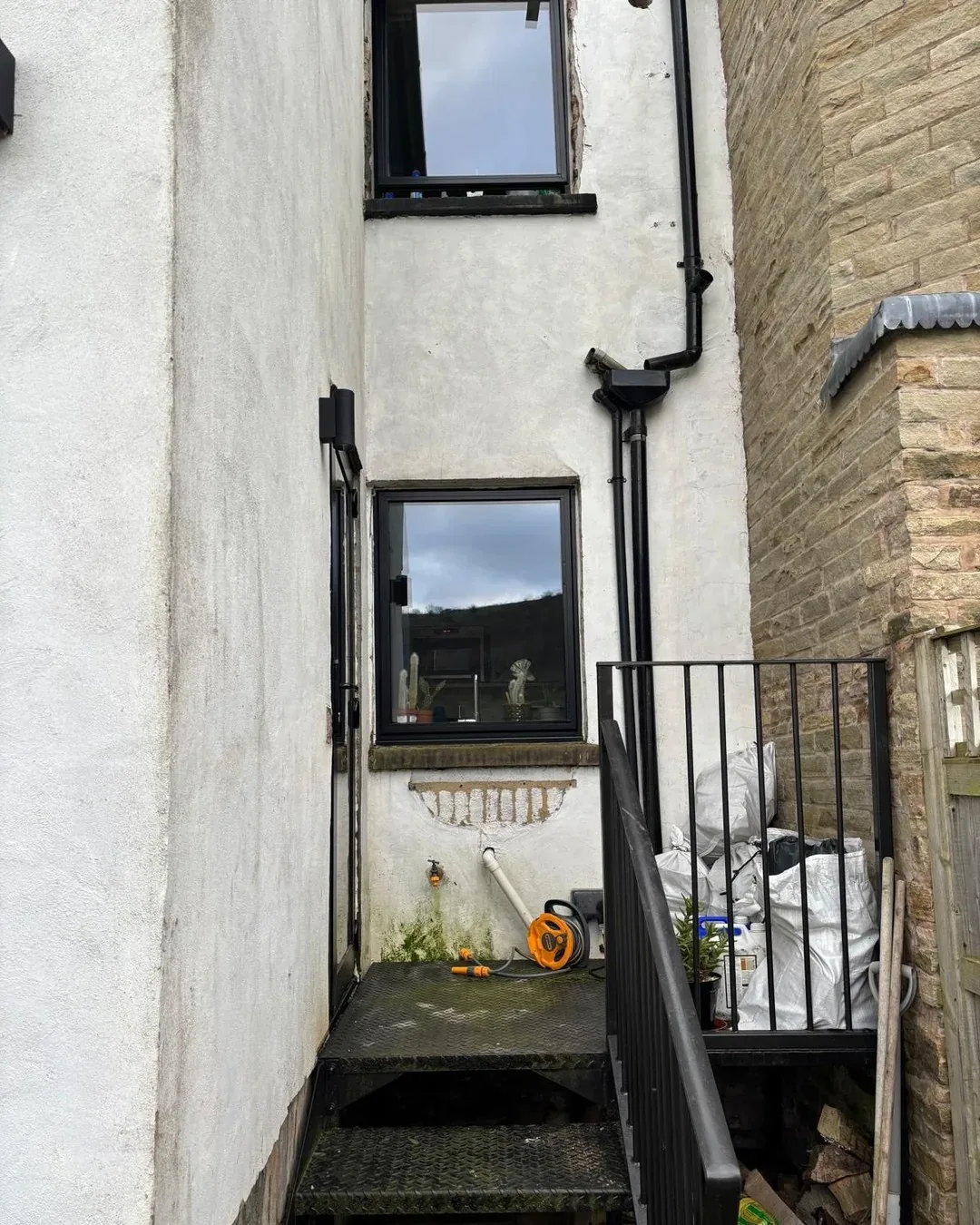 Exterior wall before original stonework was revealed and restored.
