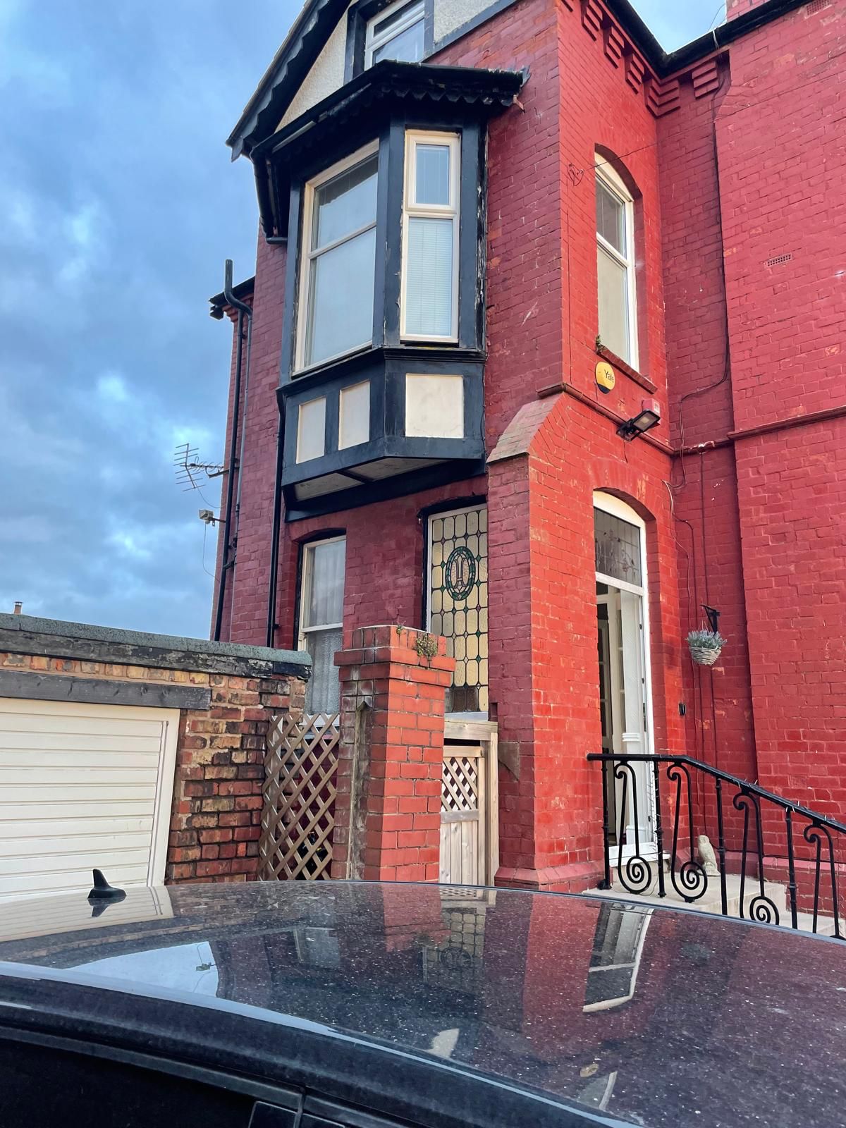 Painted Victorian four-storey property before masonry restoration.