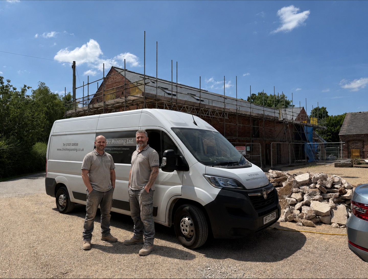 Specialist masonry team working on site with scaffolding and equipment.